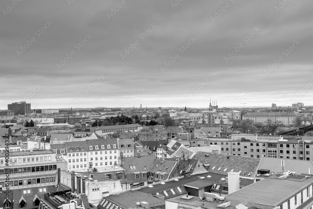 Black and white of aerial view of old downtown of Copenhagen City from the The Round Tower (Rundetaarn) in rainy misty day with cloudy sky with red house roofs and churchs