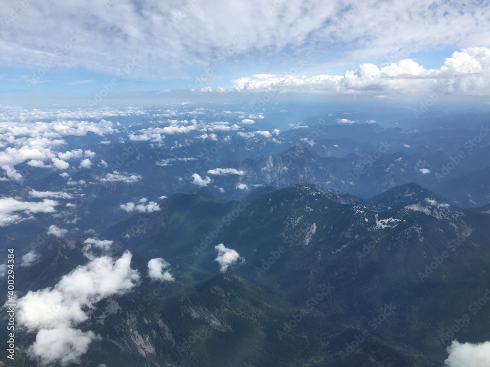Mountain range view with clouds from an airplane window.