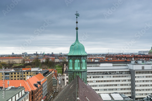 Aerial view of Copenhagen City from the The Round Tower (Rundetaarn) in rainy misty day with cloudy sky and building of tower of Trinitatis Church (Trinitatis Kirke)