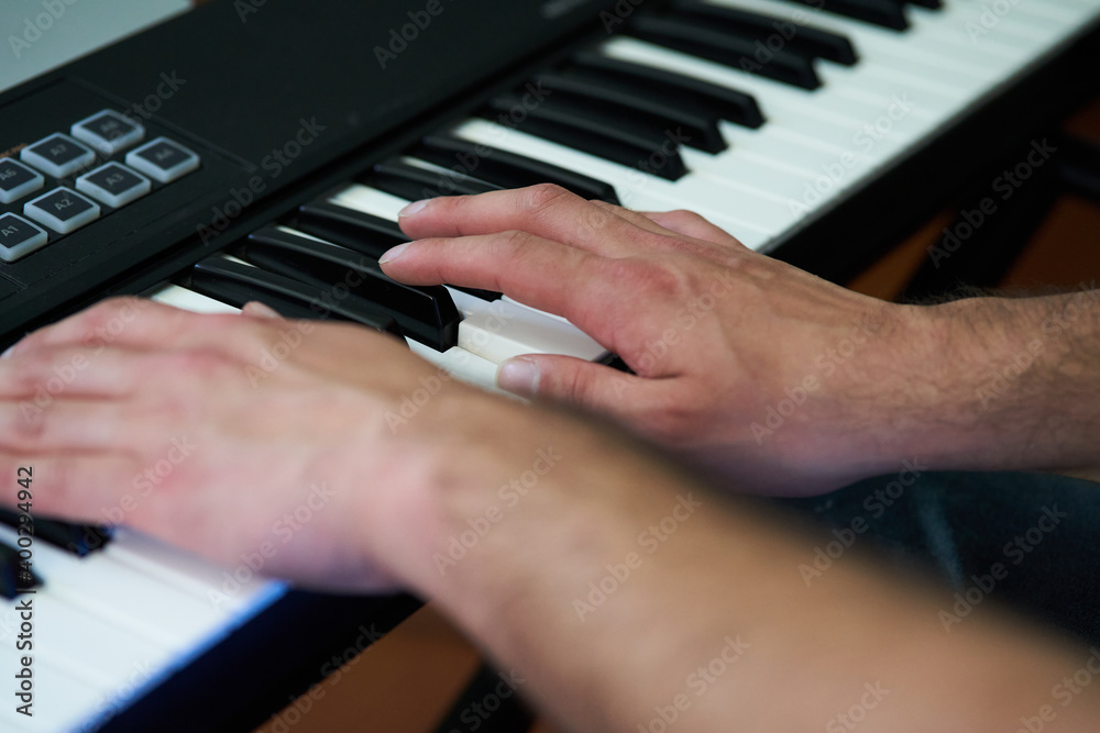 Fototapeta premium detail shot of the pianist's fingers