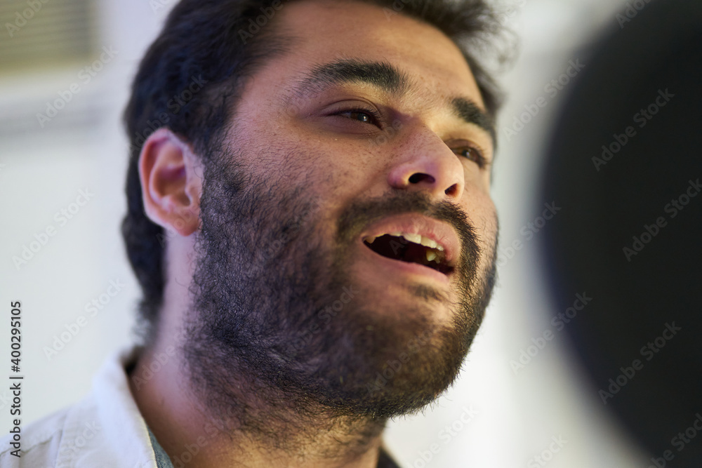 Obraz premium close-up of musician singing softly in front of the microphone
