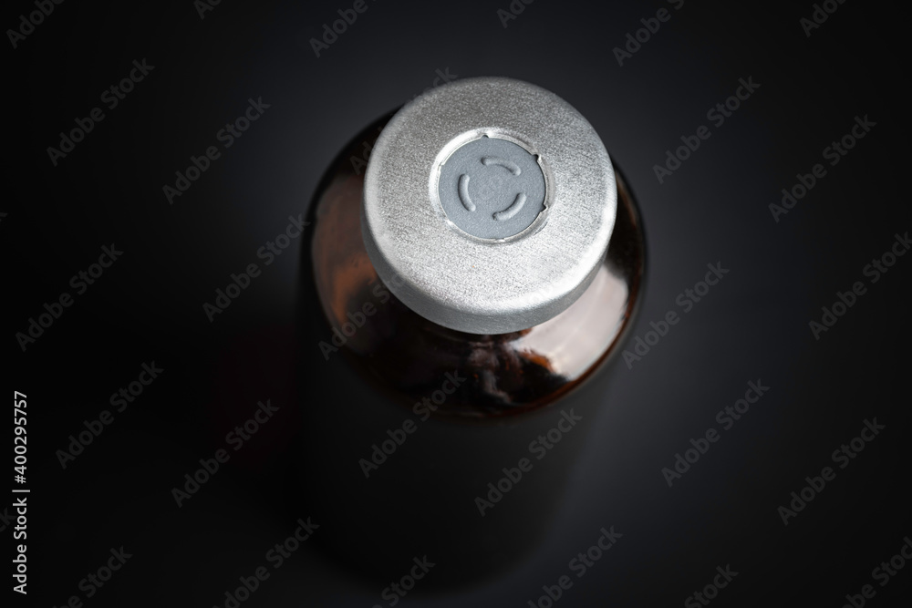 Macro Image Of Amber Vaccine Vial In Black Background Macro Image Of Amber Vaccine Vial In Black Background