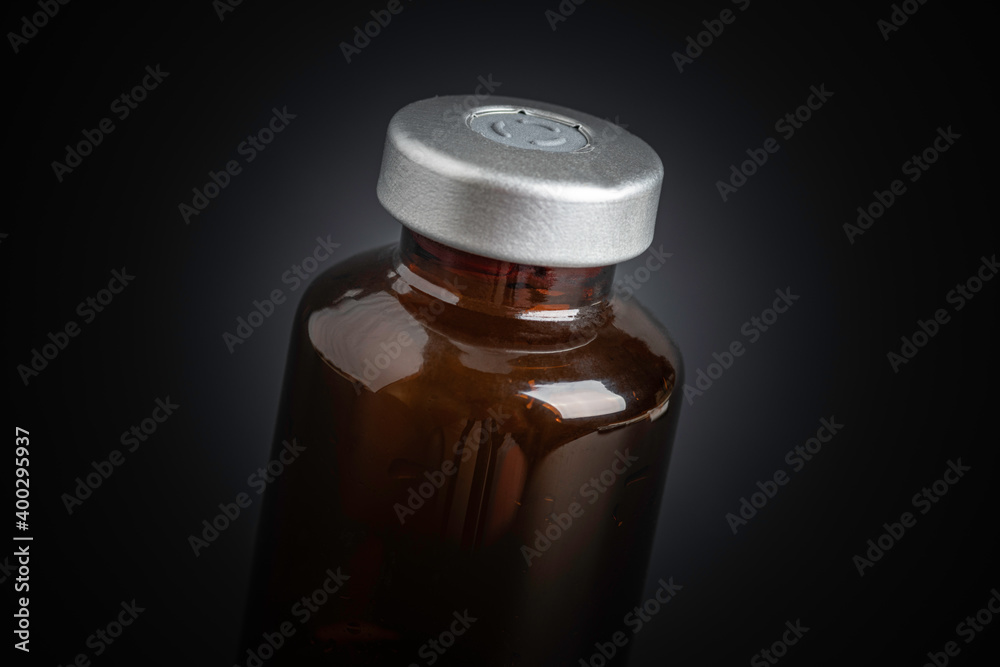 Macro Image Of Amber Vaccine Vial In Black Background Macro Image Of Amber Vaccine Vial In Black Background
