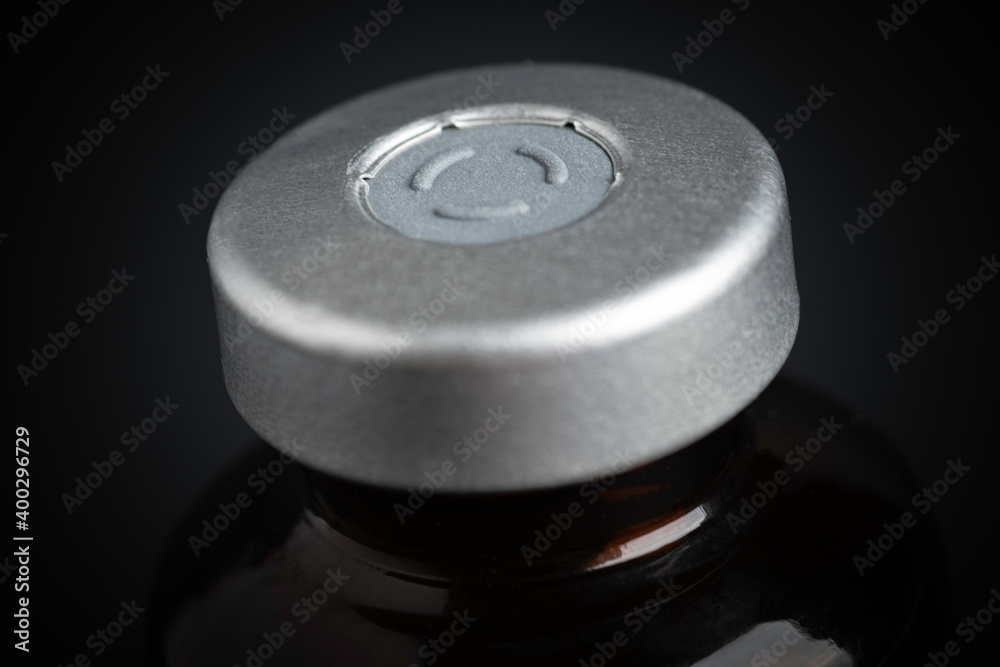 Macro Image Of Amber Vaccine Vial In Black Background Macro Image Of Amber Vaccine Vial In Black Background