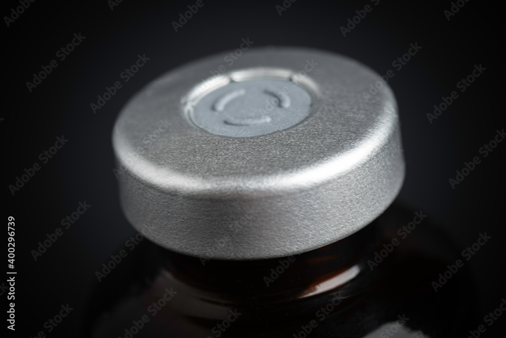 Macro Image Of Amber Vaccine Vial In Black Background Macro Image Of Amber Vaccine Vial In Black Background