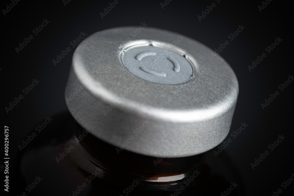 Macro Image Of Amber Vaccine Vial In Black Background Macro Image Of Amber Vaccine Vial In Black Background