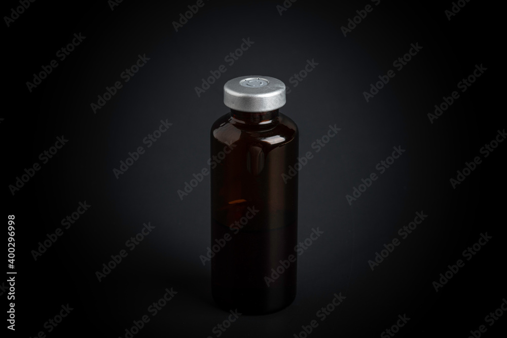 Macro Image Of Amber Vaccine Vial In Black Background Macro Image Of Amber Vaccine Vial In Black Background