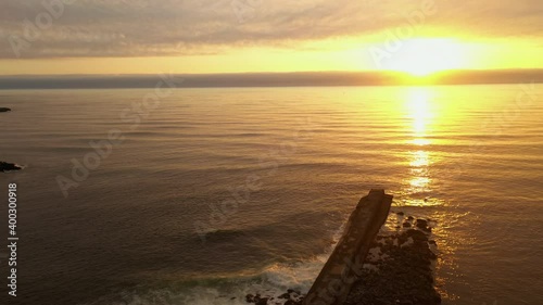 Drone flying over jetty into the sunset in Pacific Ocean  photo
