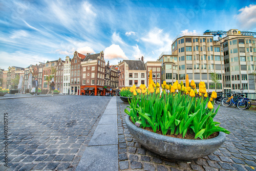 AMSTERDAM, THE NETHERLANDS - APRIL 25, 2015: Tourists and locals wlak along the city streets photo