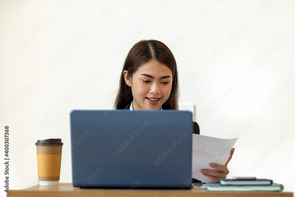Young Asian businesswoman working with laptop at her house, work from home, business concept Young Asian businesswoman working with laptop at her house, work from home, business concept