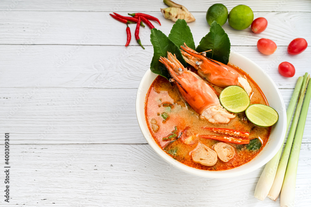 Tom yum soup. Tom yam kung is a thai spicy soup with shrimps, lemongrass,lime, ginger, galangal and coconut milk. Thai food. Space for text Tom yum soup. Tom yam kung is a thai spicy soup with shrimps, lemongrass,lime, ginger, galangal and coconut milk. Thai food. Space for text