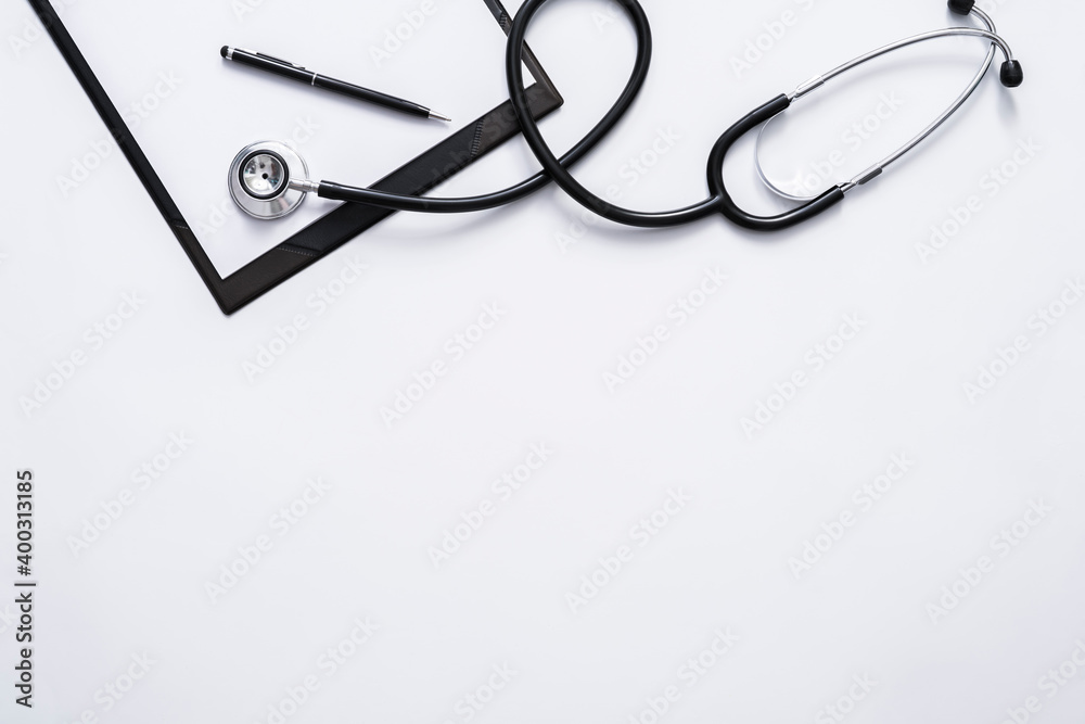 Flat lay of doctor desk with stethoscope, clipboard and pen with copy space for text. Flat lay of doctor desk with stethoscope, clipboard and pen with copy space for text.