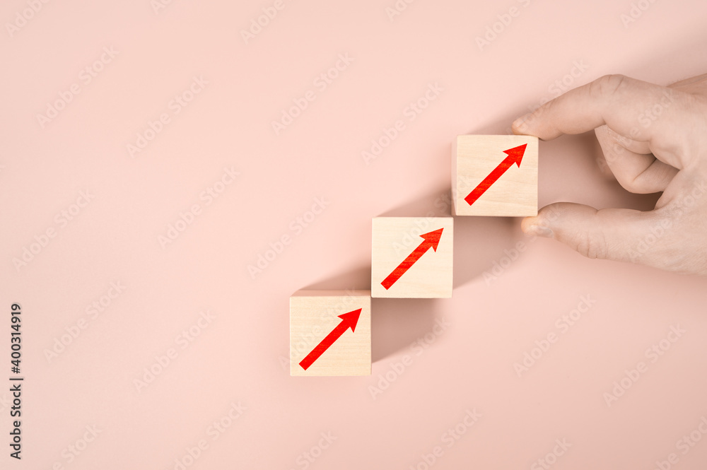 Business concept growth success process, Close up man hand arranging wood block stacking as step stair on pink background, copy space. Business concept growth success process, Close up man hand arranging wood block stacking as step stair on pink background, copy space.