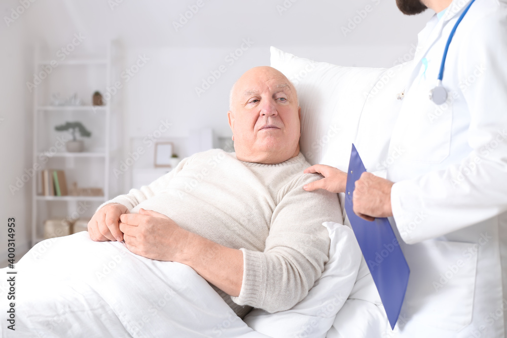 Doctor and senior man undergoing course of chemotherapy in clinic. Prostate cancer awareness concept Doctor and senior man undergoing course of chemotherapy in clinic. Prostate cancer awareness concept