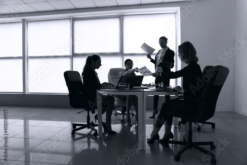 Silhouettes of businesswomen working in office