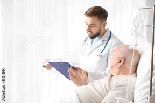 Doctor and senior man under...