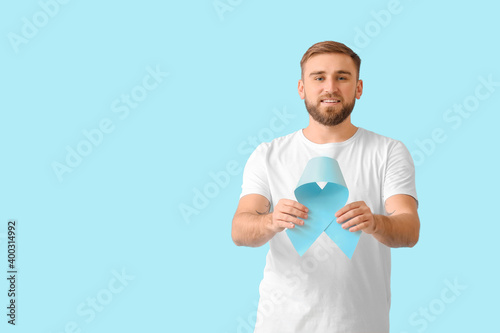 Man with blue ribbon on col...