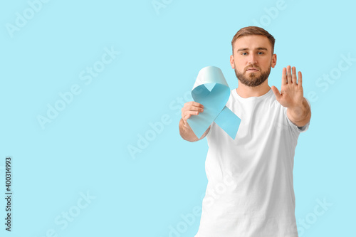 Man with blue ribbon on col...