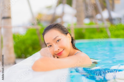 Portrait beautiful young asian woman relax leisure around outdoor swimming pool