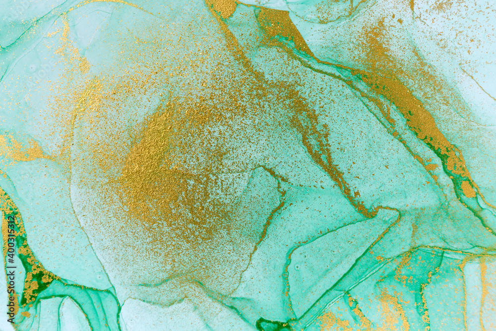 Alcohol ink green and gold abstract stains background.