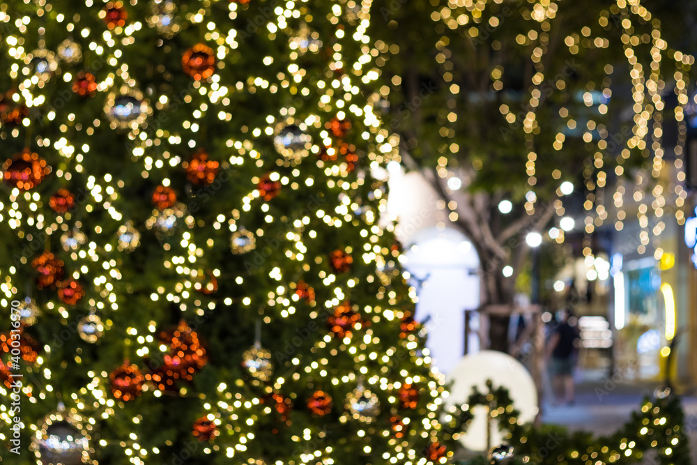 Blurred image Christmas tree and Christmas decorations  beautiful outdoor at street in park