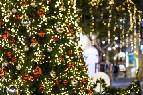 Blurred image Christmas tree and Christmas decorations  beautiful outdoor at street in park © piyaphunjun