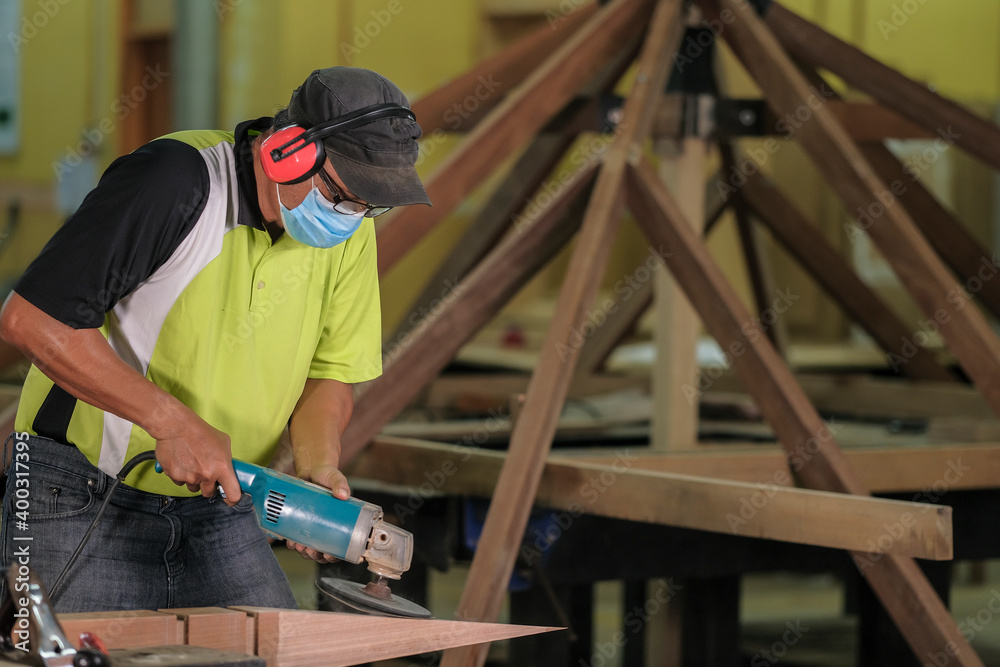 Carpenter making Tunjuk Langit or one of the roof structures. Hip Roof Carpenter making Tunjuk Langit or one of the roof structures. Hip Roof