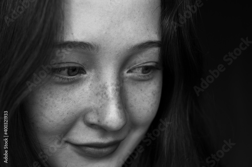 close up portrait of a young woman with freckles