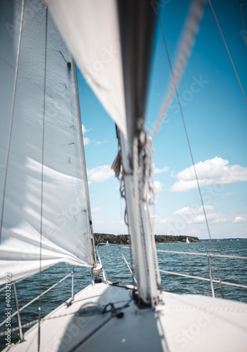 Sailing on lake Chiemsee in Bavaria on a sailing boat on a warm summer day with lots of wind in sails
