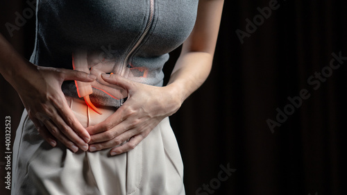 Abdominal pain woman, photo of large intestine on woman body, appendix pain. Health care concept.