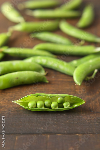 Fresh green peas isolated on wooden table