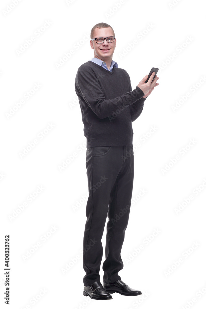 Smiling young man in glasses looking at camera and holding his smart phone Smiling young man in glasses looking at camera and holding his smart phone