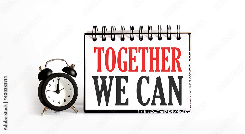 Together We Can notepad writing on white background with alarm clock Together We Can notepad writing on white background with alarm clock