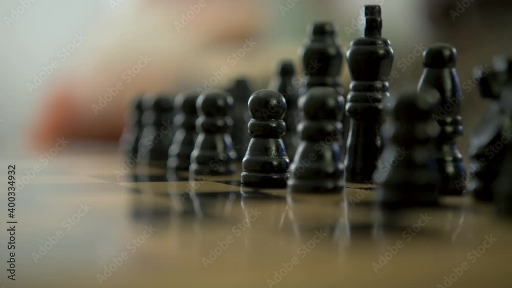 Black wooden chess pieces arranged for game