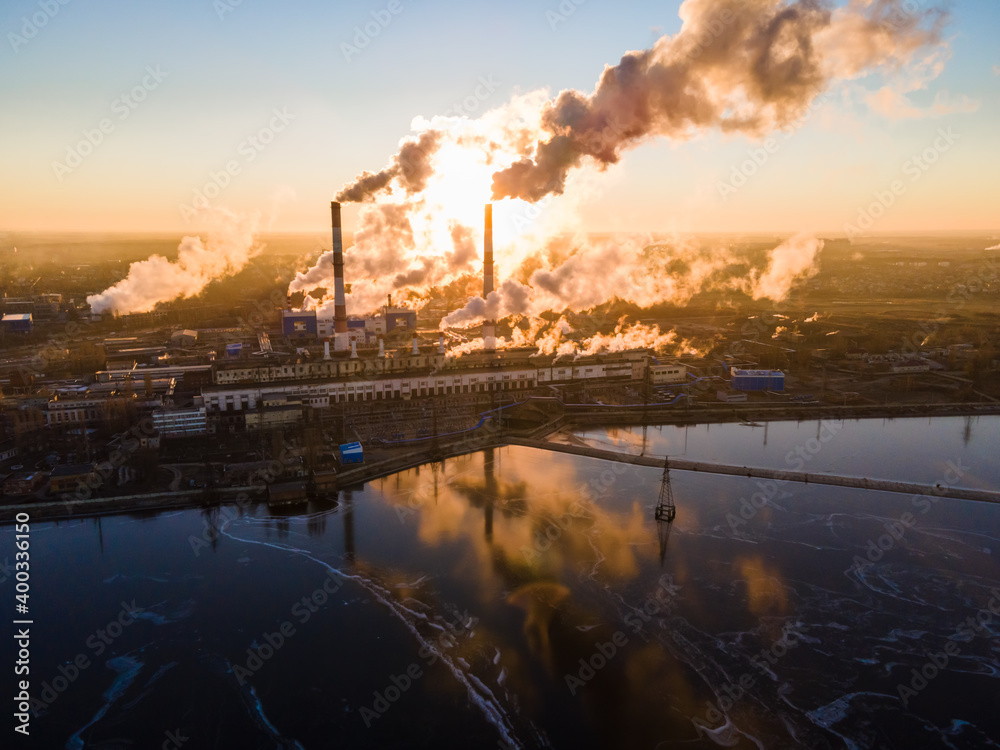 Aerial view Forward Cityscape sunrise Factory chimney smoke building steam thermal power plant. Factory production industrial, ecology pollution of air