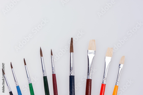 Row of colorful paint brushes. Isolated with copy space