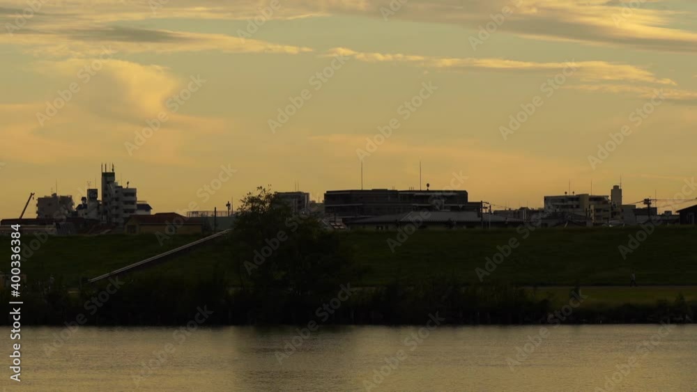 The silhouette of the evening sky and the city seen from the river skewer