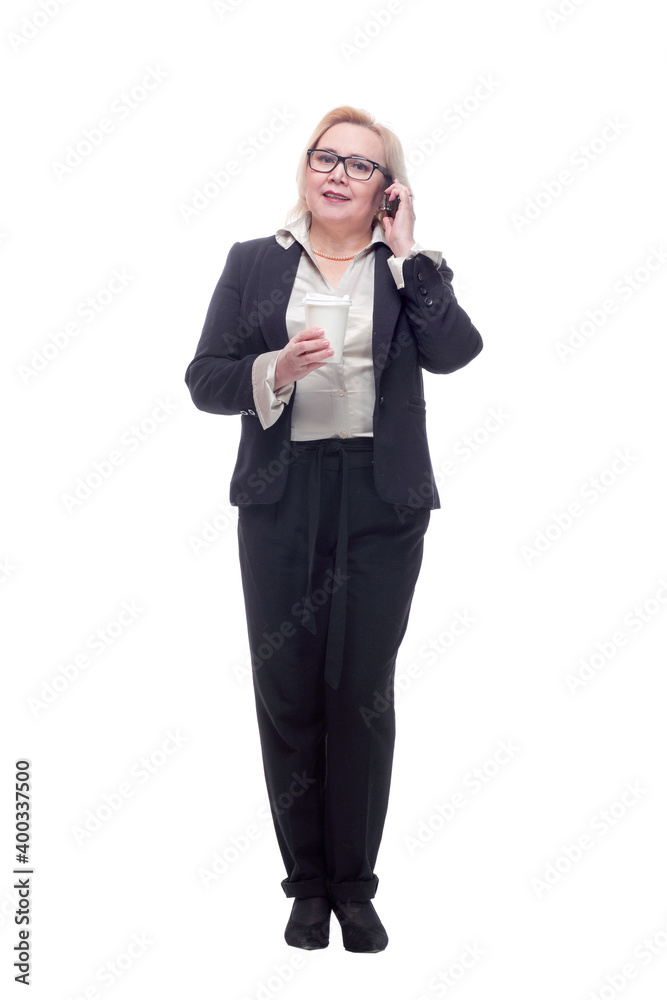 Woman smiling and talking on her phone holding a cup of coffee Woman smiling and talking on her phone holding a cup of coffee