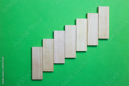ascending graphic with pieces of wood and green background. to fill with words or drawings. copy for space. space for text and drawings