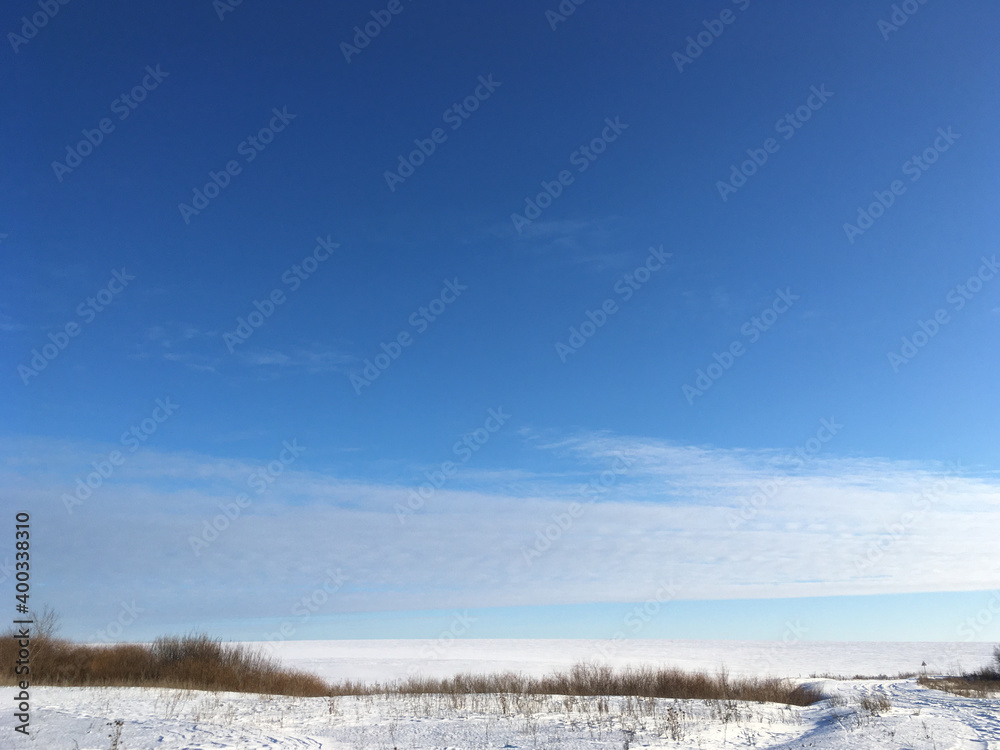 Endless winter landscape on a sunny day with blue sky