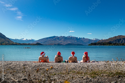 tourists in christmas hats on a beach of wanaka new zealand
