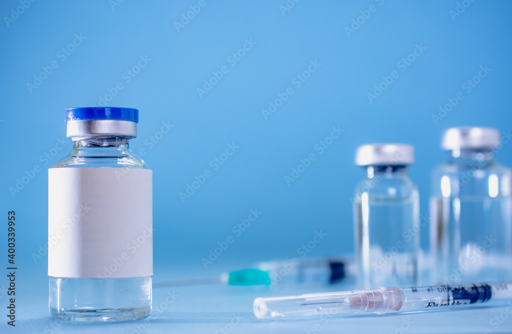 Medical treatment syringes and vaccine bottles in blue environment Medical treatment syringes and vaccine bottles in blue environment