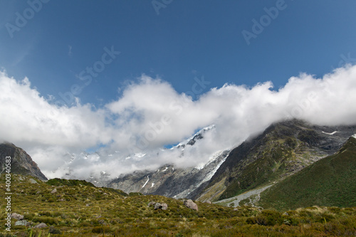 ice ridge peeking through clouds in the mountain
