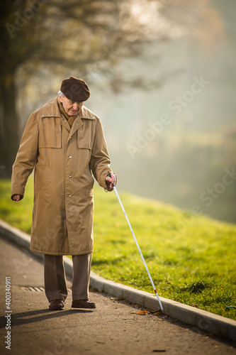 Blind man crossing a street photo