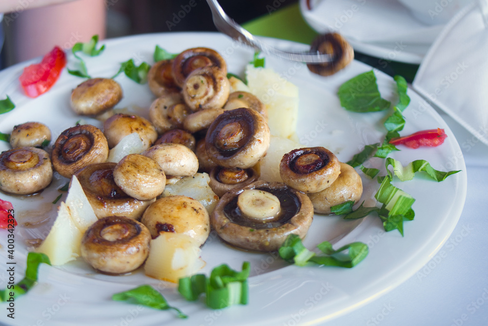Delicious vegetarian dish - buttered grilled mushrooms with herbs
