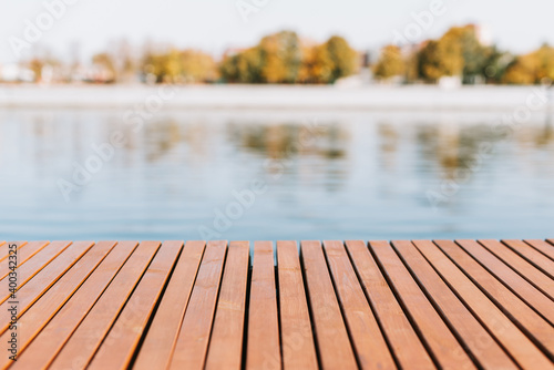 Wooden plank floor on the background of a pond