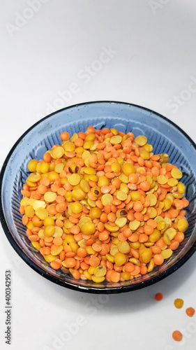 split chickpeas in glass bowl on a white isolated surface