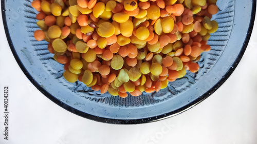 split chickpeas in glass bowl on a white isolated surface