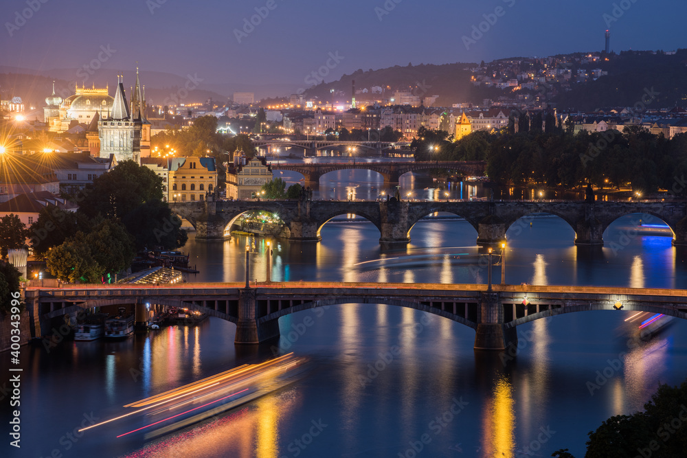Vltava River and Prague cityscape at sunset.