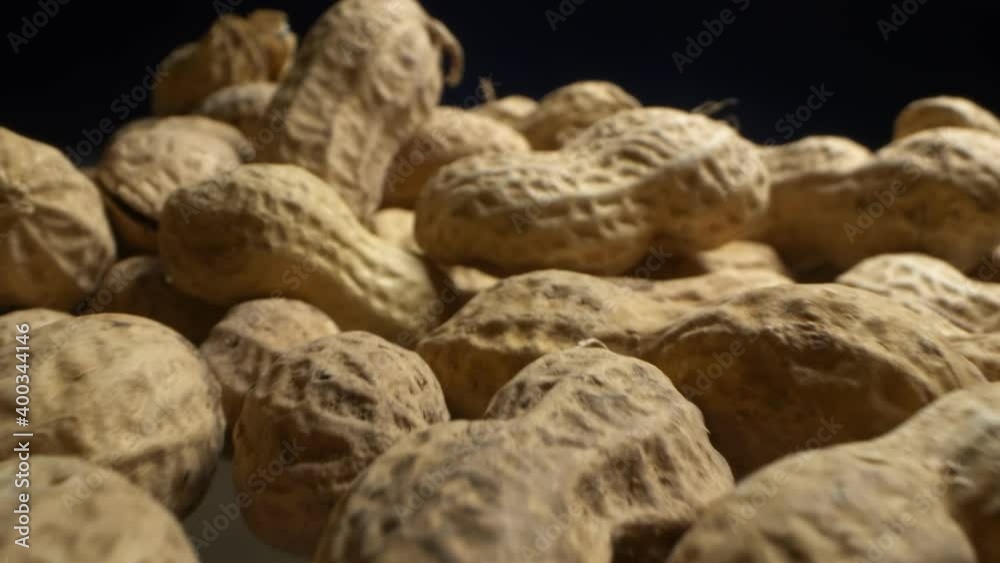 extremely close-up, detailed. peanuts in shells on a dark background. extremely close-up, detailed. peanuts in shells on a dark background.